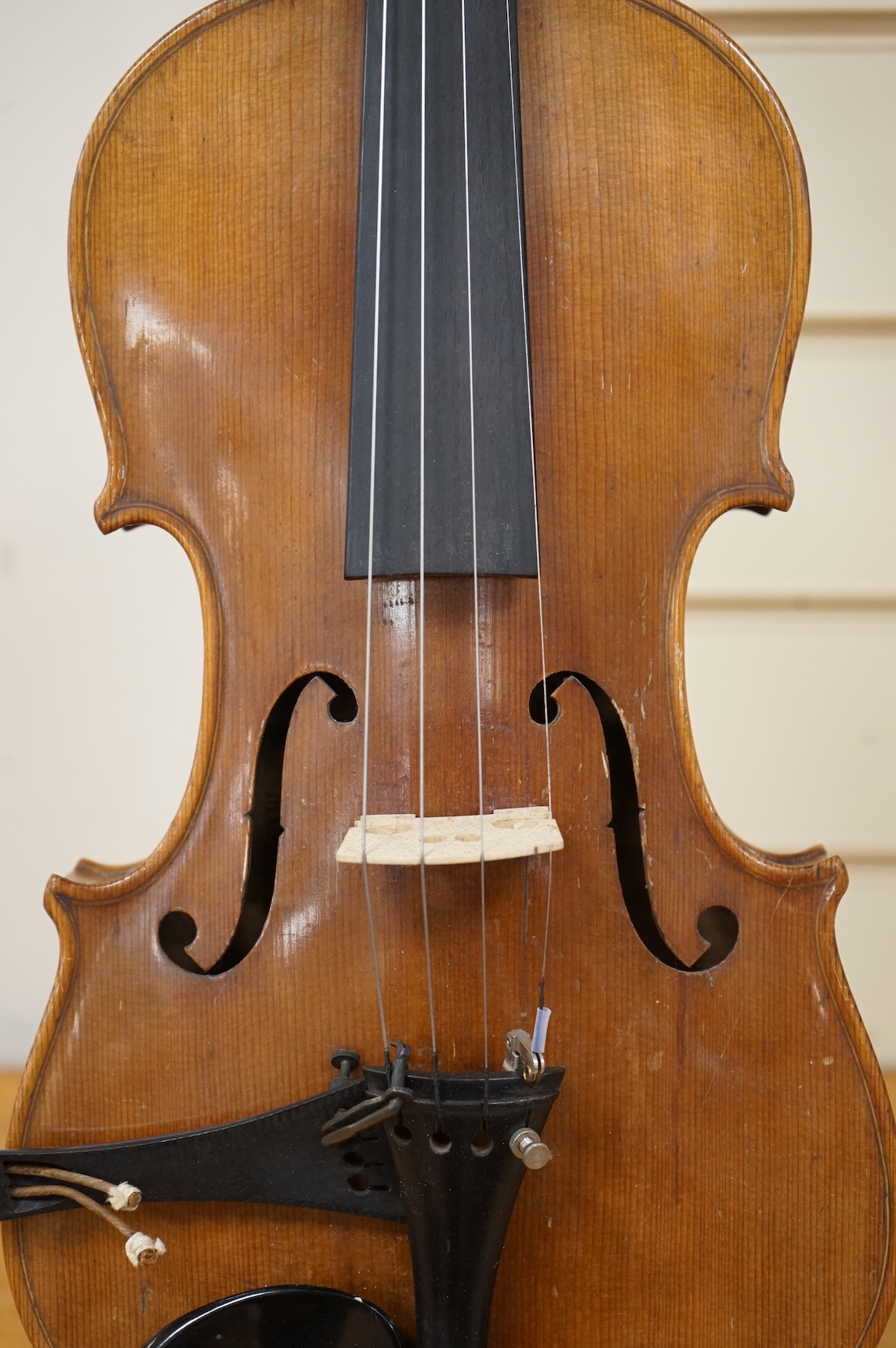 Five cased 20th century violins, including; a German violin, two Czech violins, a three-quarter size violin with a label for Bienfait, and a Romanian quarter size violin, all in cases or the remains of cases.